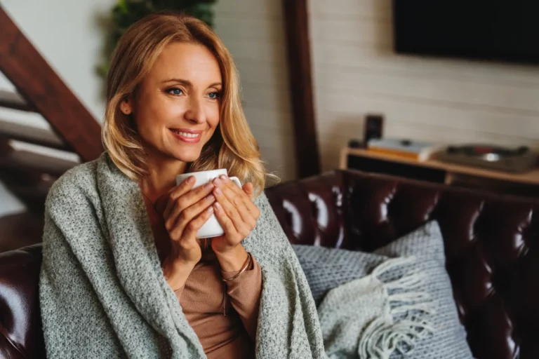 mature woman cozy in home feeling happy about her Improved Insulation